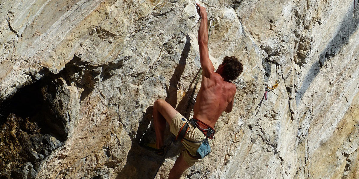 Fotografía de deportes extremos con un escalador subiendo una pared